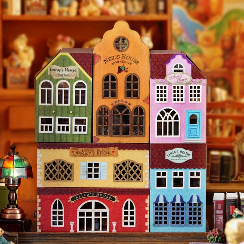 a toy house with a clock on top of it