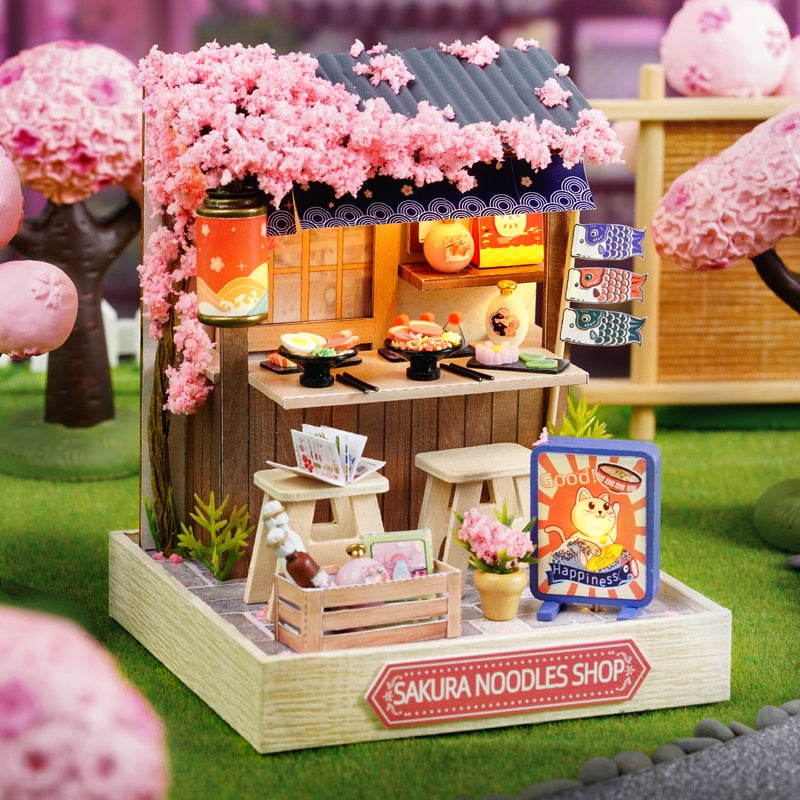 a doll house made of wood with pink flowers