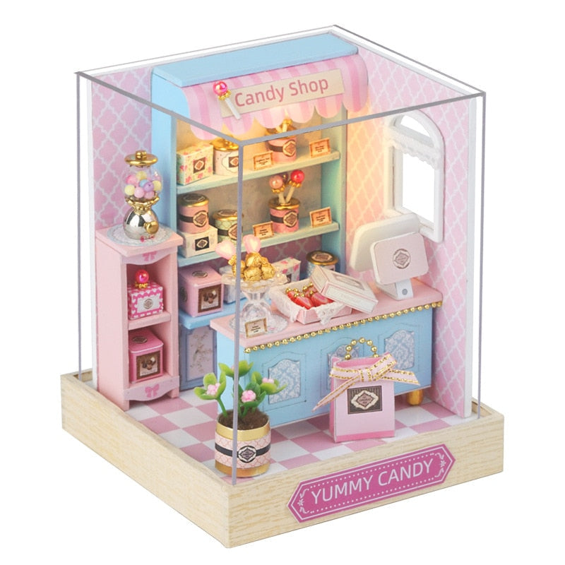 a pink and blue doll house with a candy shop