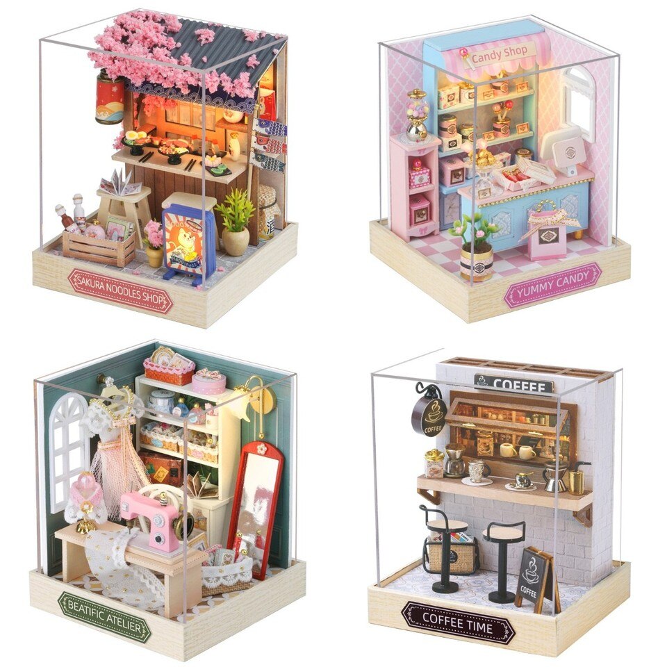 a set of three miniature doll houses with furniture